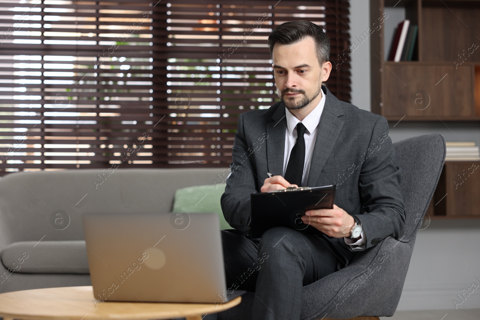 Photo of Professional psychologist having online consultation with his client via laptop indoors. Space for text