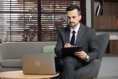 Photo of Professional psychologist having online consultation with his client via laptop indoors. Space for text