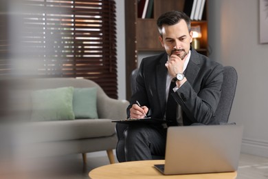 Photo of Professional psychologist having online consultation with his client via laptop indoors. Space for text
