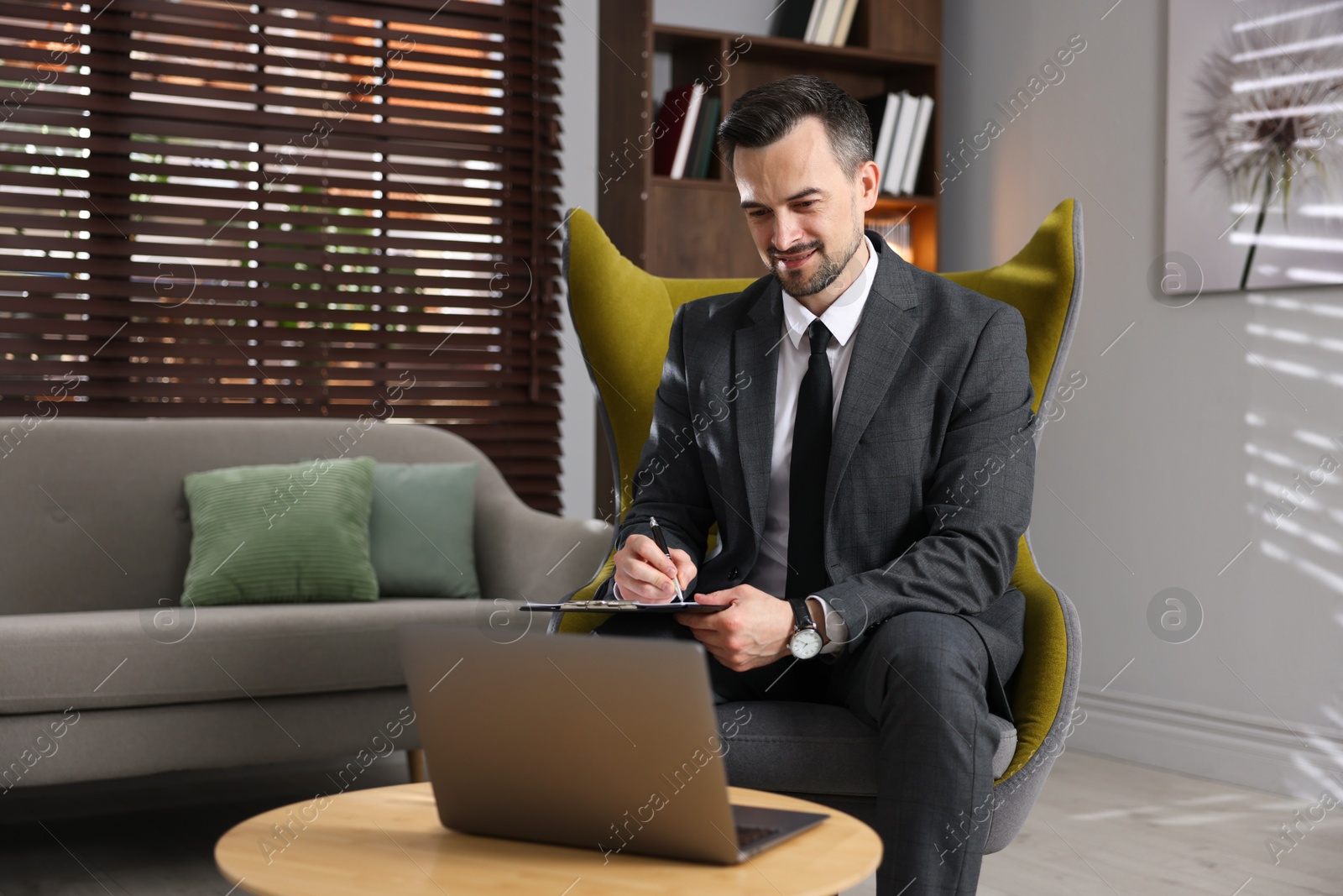 Professional psychologist having online consultation with his client via laptop indoors Photo of Professional psychologist having online consultation with his client via laptop indoors