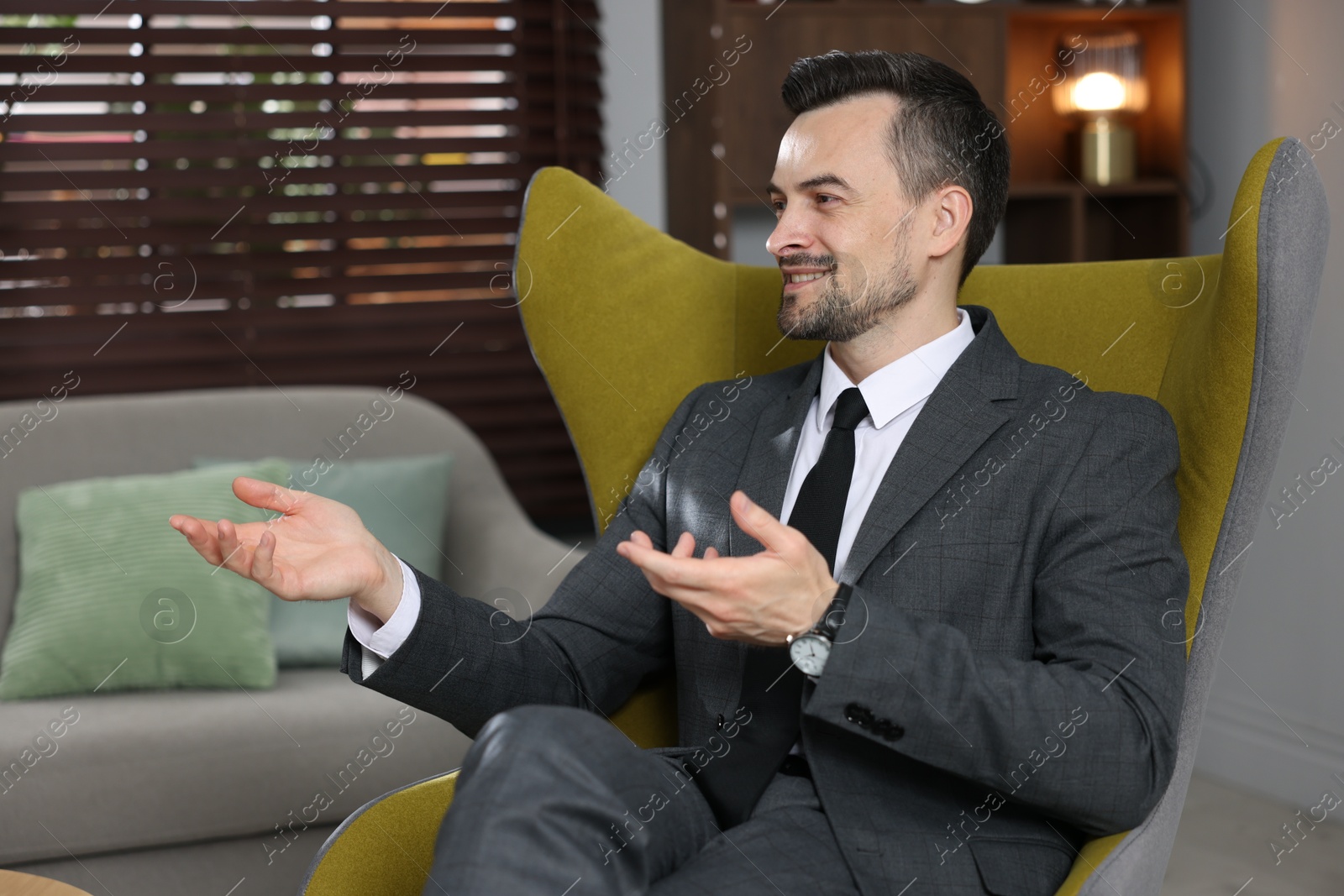 Professional psychologist in armchair at his office Photo of Professional psychologist in armchair at his office