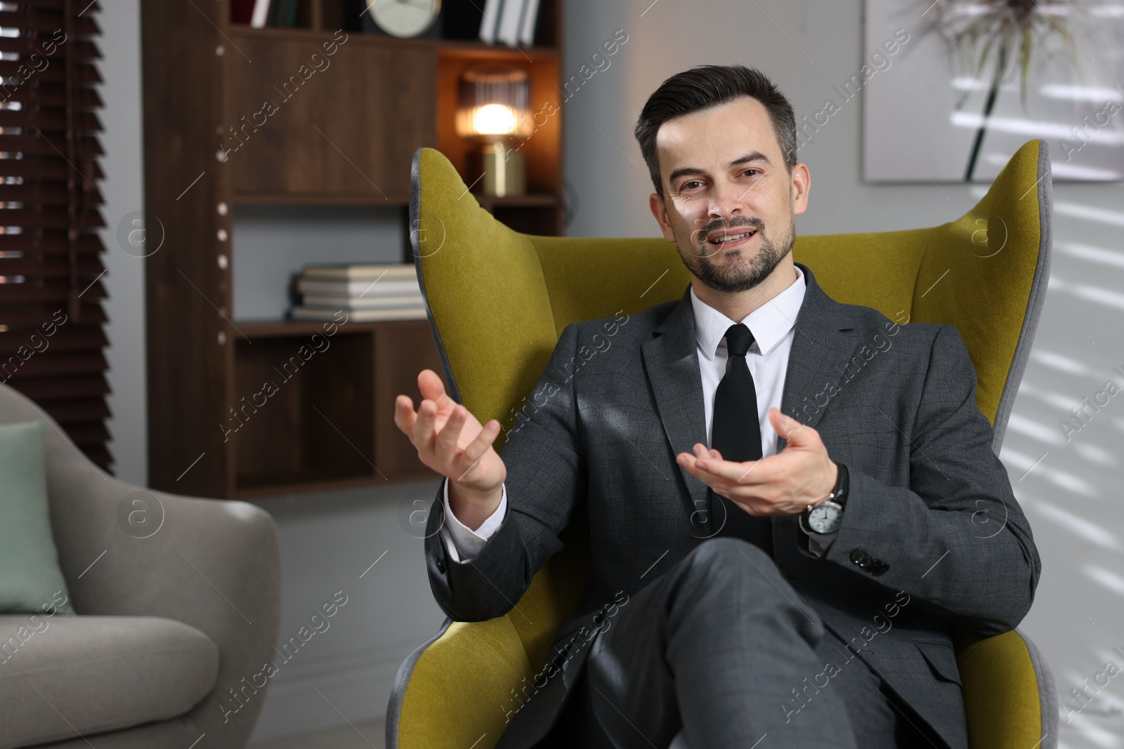 Professional psychologist in armchair at his office Photo of Professional psychologist in armchair at his office
