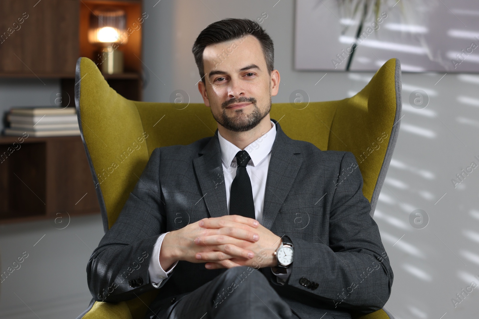 Professional psychologist in armchair at his office Photo of Professional psychologist in armchair at his office