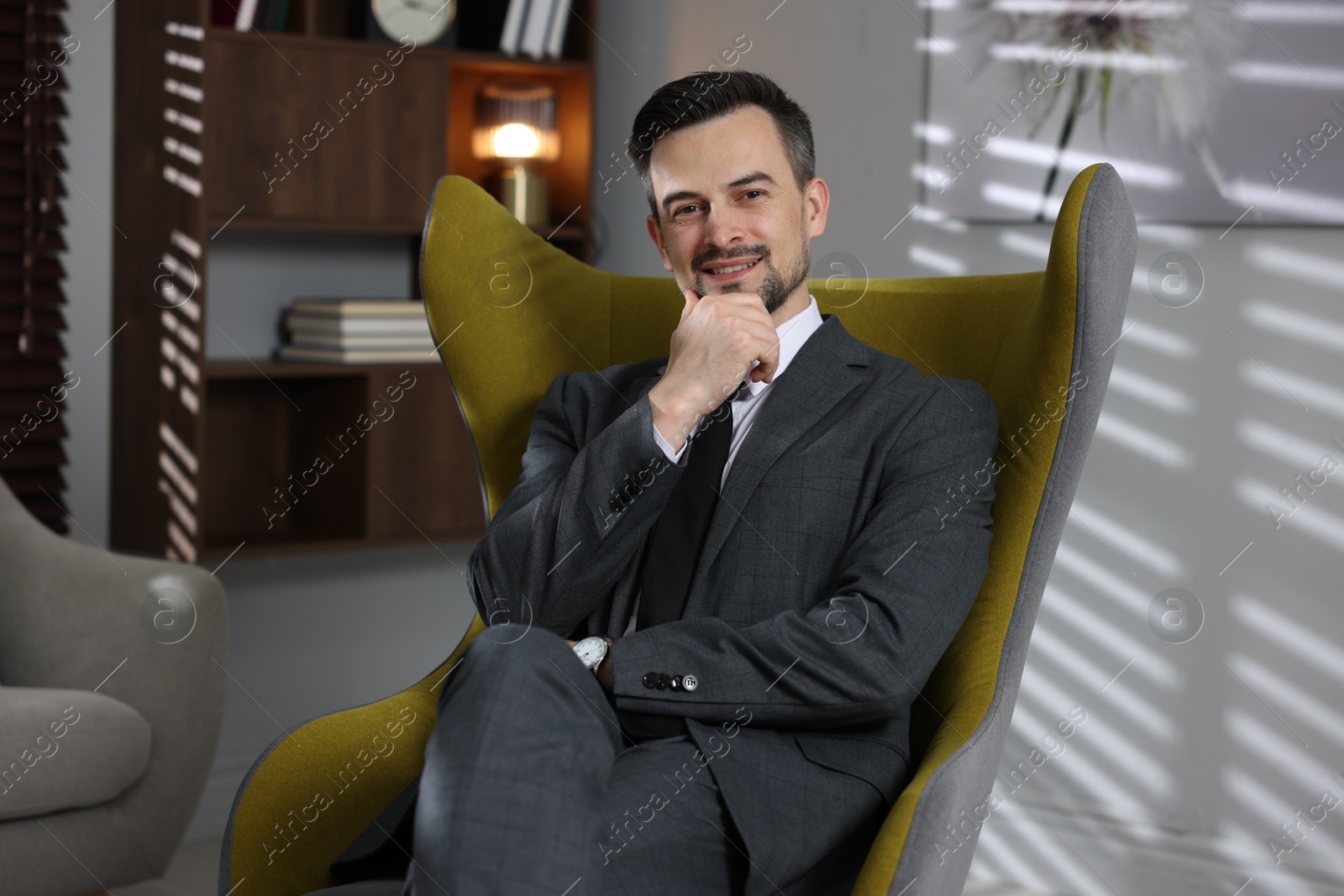 Professional psychologist in armchair at his office Photo of Professional psychologist in armchair at his office