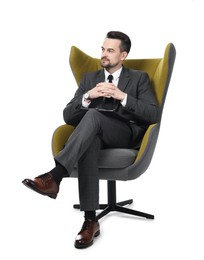 Photo of Professional psychologist with clipboard in armchair on white background