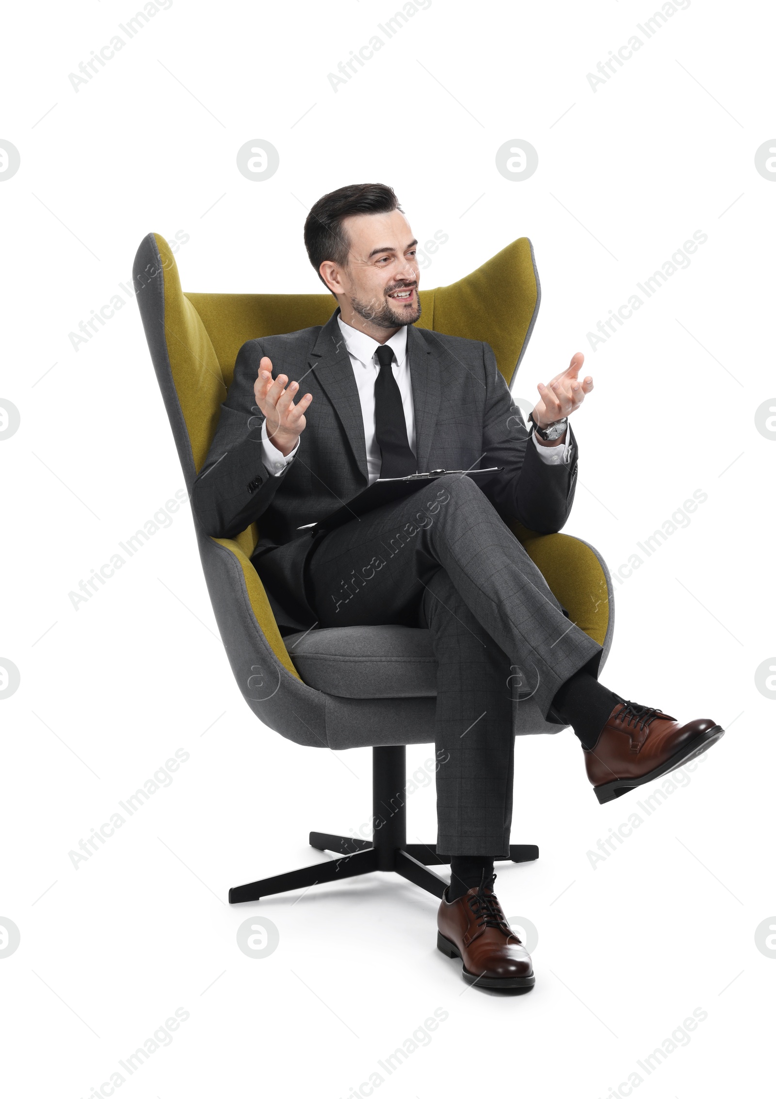 Professional psychologist with clipboard in armchair on white background Photo of Professional psychologist with clipboard in armchair on white background
