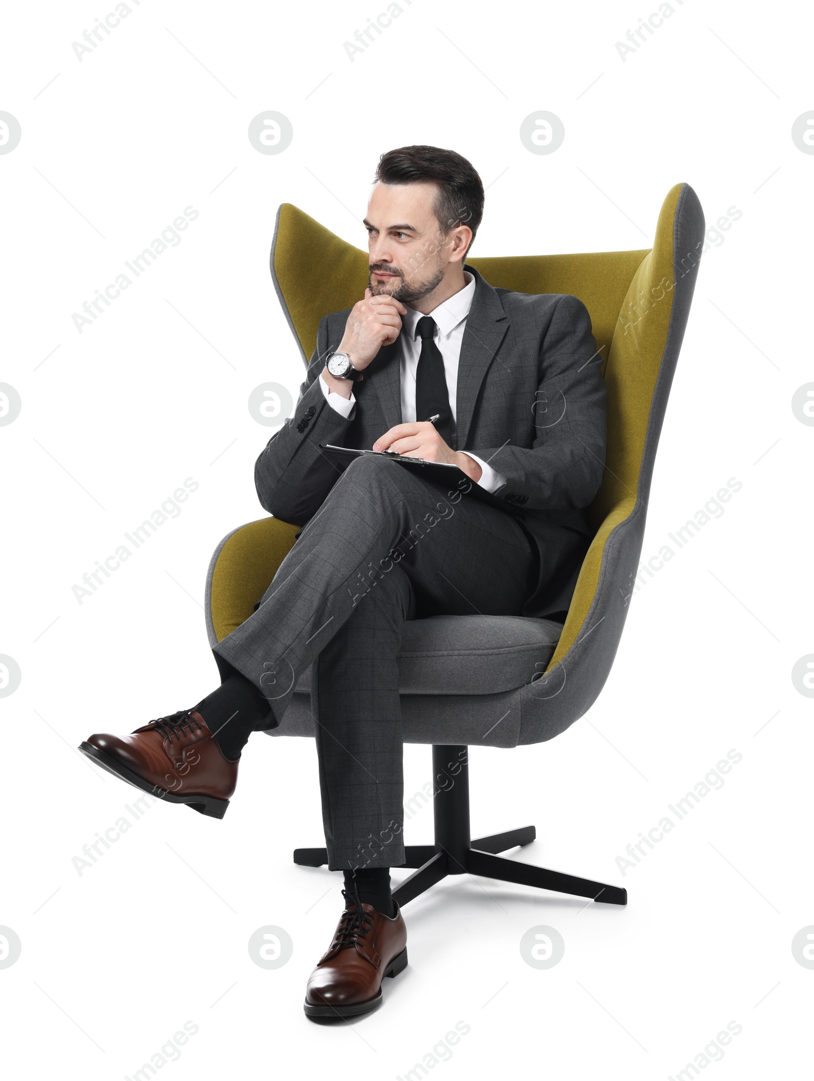 Professional psychologist with clipboard in armchair on white background Photo of Professional psychologist with clipboard in armchair on white background