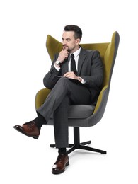 Photo of Professional psychologist with clipboard in armchair on white background