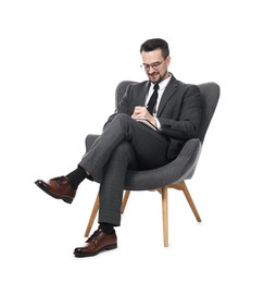 Photo of Professional psychologist with notebook in armchair on white background
