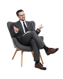 Photo of Professional psychologist with notebook in armchair on white background