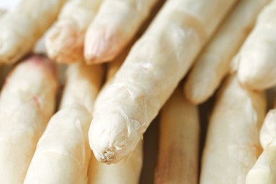 Photo of Raw white asparagus spears as background, closeup