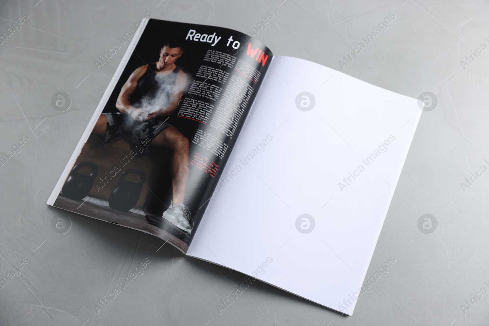 Open magazine on light grey table. Mockup for design Photo of Open magazine on light grey table. Mockup for design