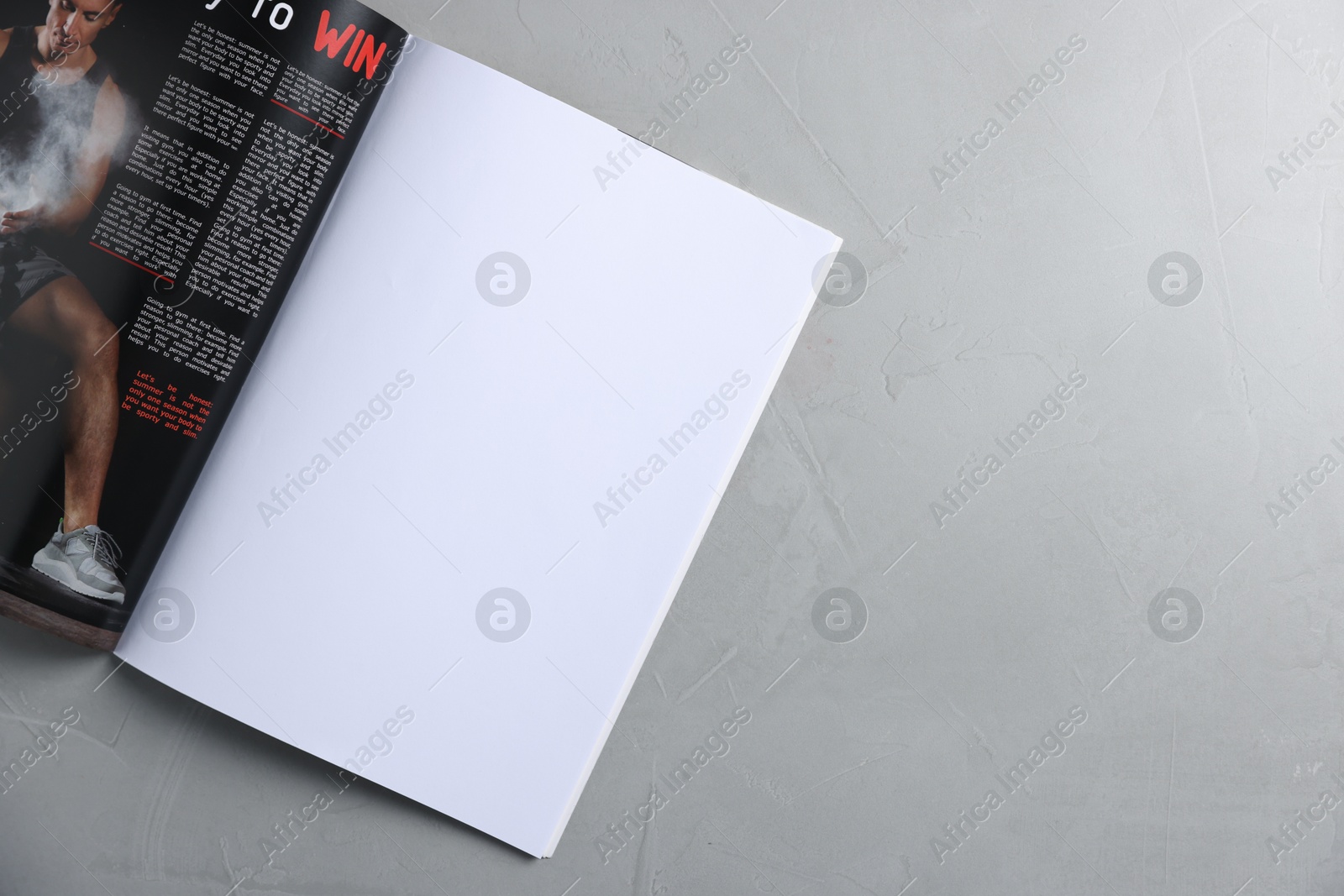Open magazine on light grey table, top view. Mockup for design Photo of Open magazine on light grey table, top view. Mockup for design