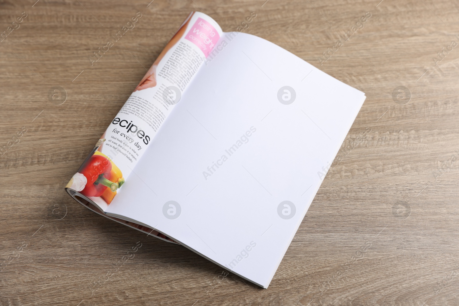 Open magazine on wooden table. Mockup for design Photo of Open magazine on wooden table. Mockup for design