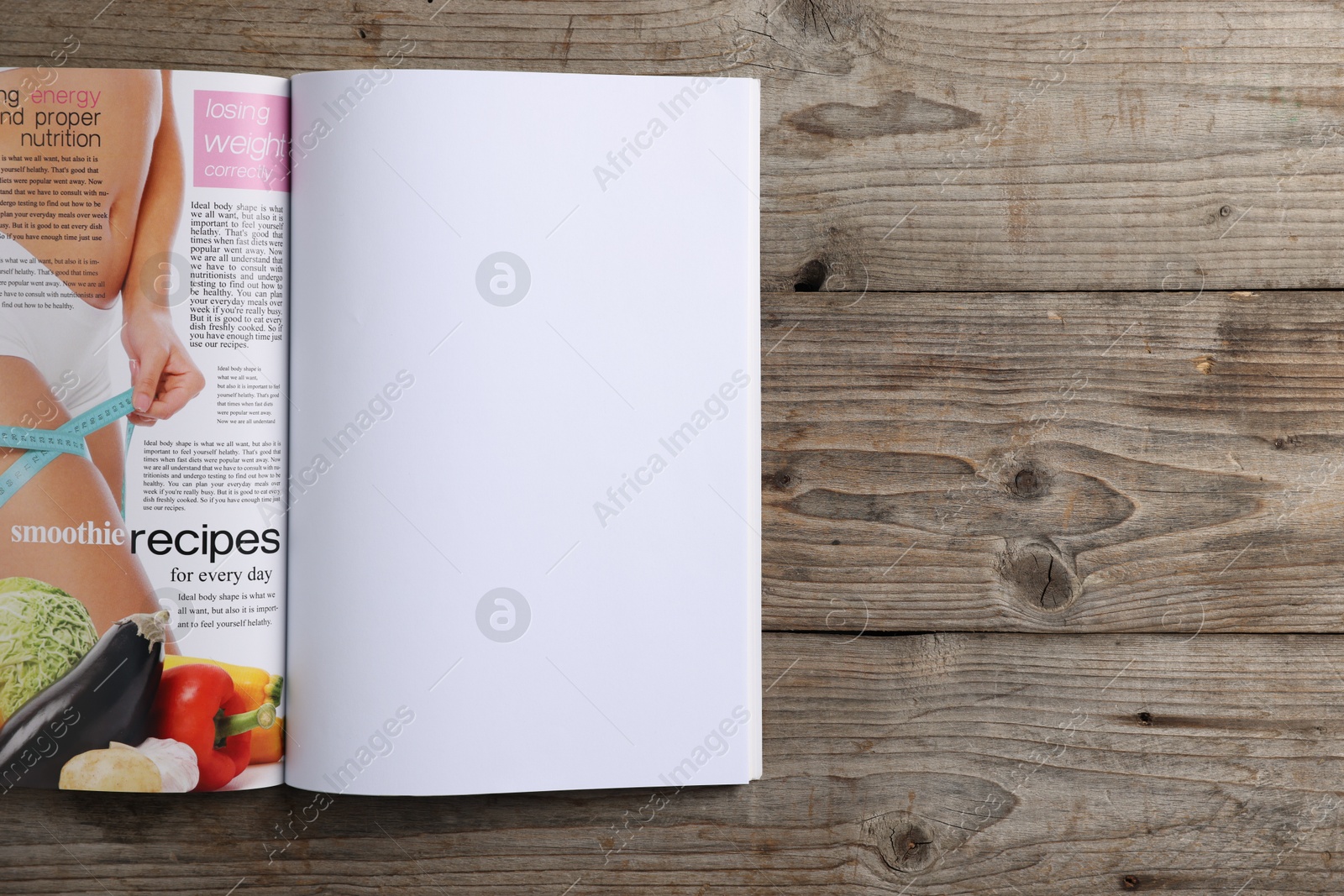 Photo of Open magazine on wooden table, top view. Mockup for design