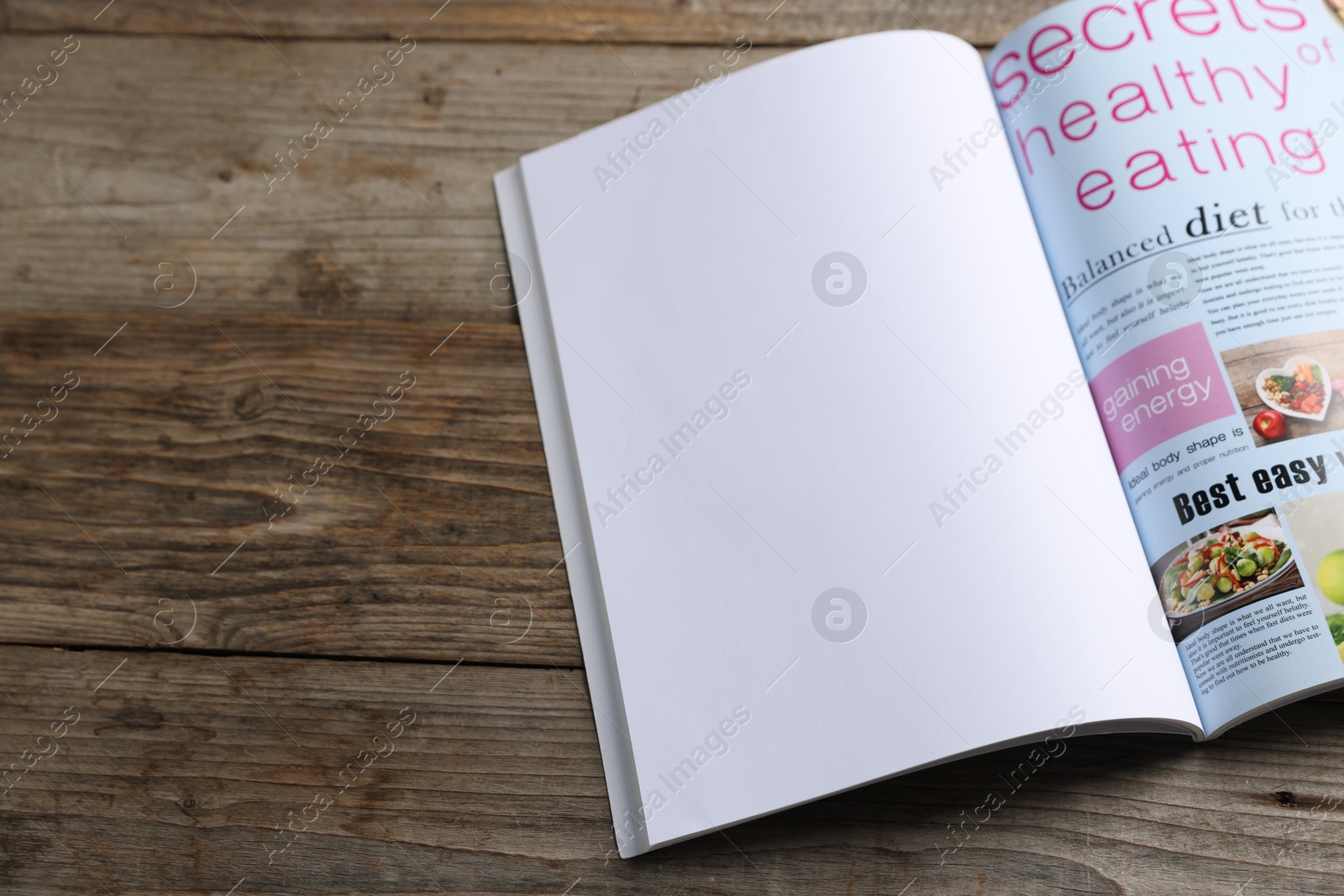 Open magazine on wooden table. Mockup for design Photo of Open magazine on wooden table. Mockup for design