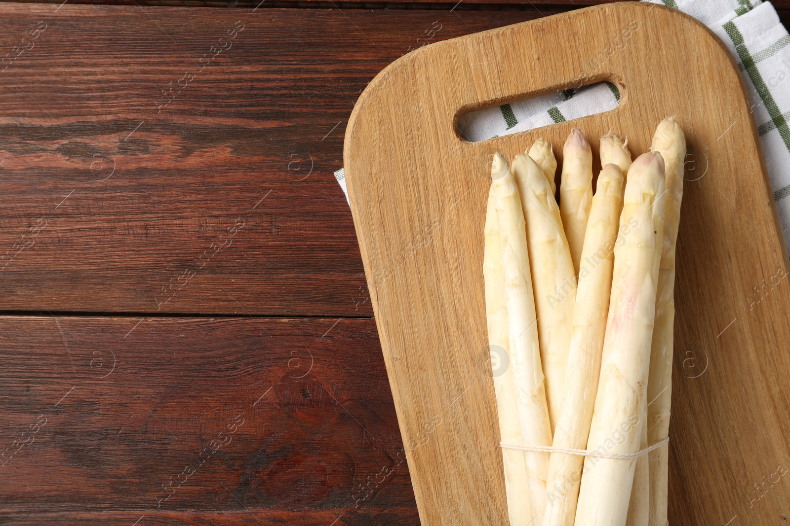 Raw asparagus spears on wooden table, top view. Space for text Photo of Raw asparagus spears on wooden table, top view. Space for text