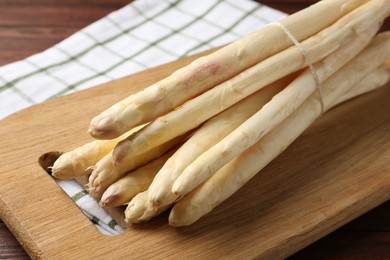Photo of Bunch of asparagus spears on table, closeup
