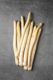 Photo of Many raw asparagus spears on grey table, flat lay