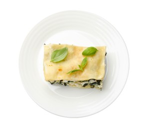 Photo of Piece of tasty vegetarian lasagna isolated on white, top view