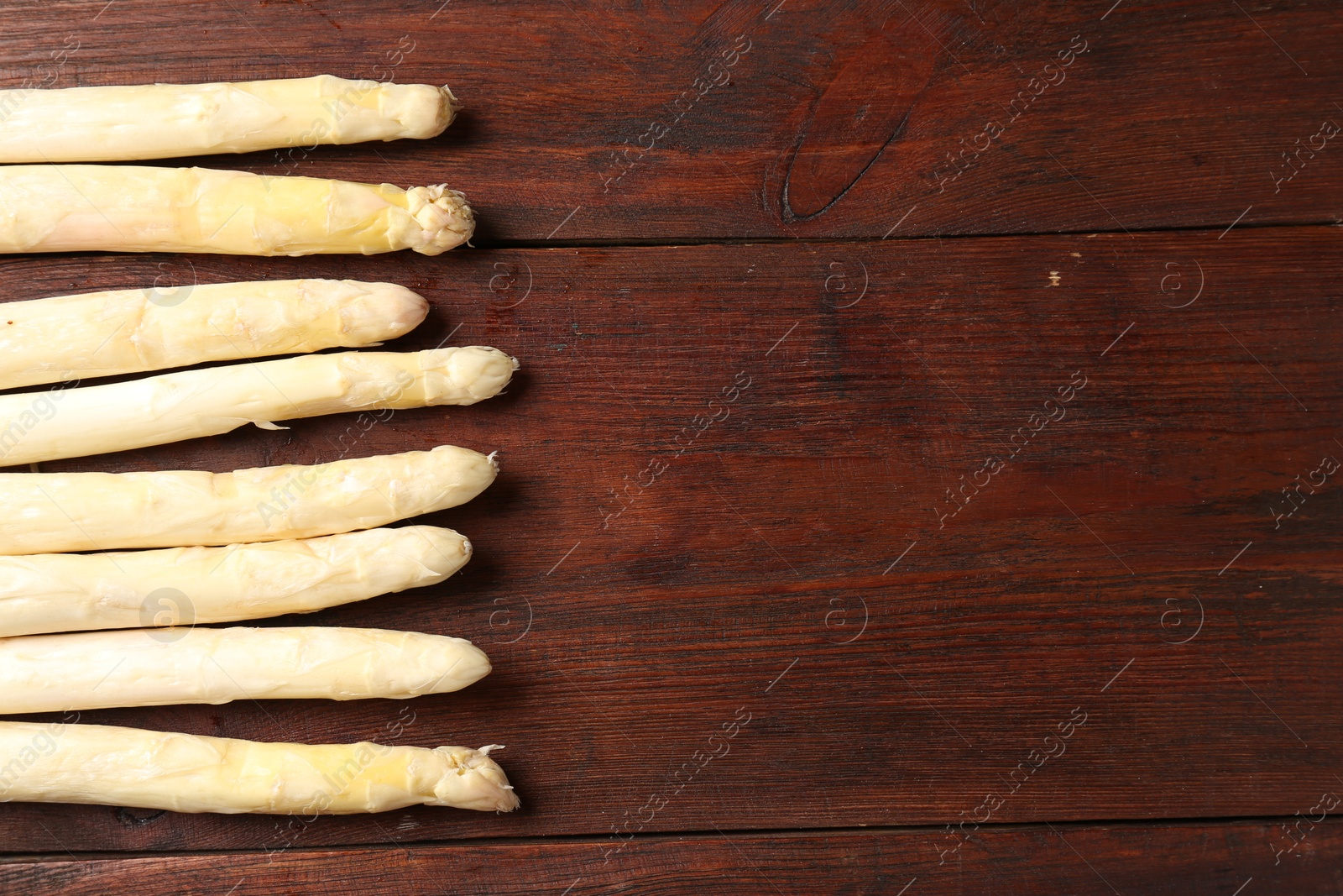 Many raw asparagus spears on wooden table, flat lay. Space for text Photo of Many raw asparagus spears on wooden table, flat lay. Space for text