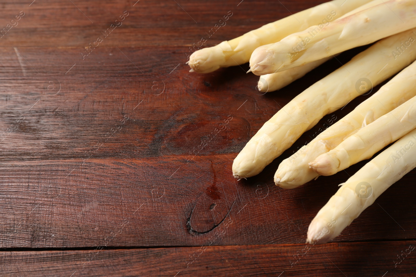 Many raw asparagus spears on wooden table, closeup, Space for text Photo of Many raw asparagus spears on wooden table, closeup, Space for text