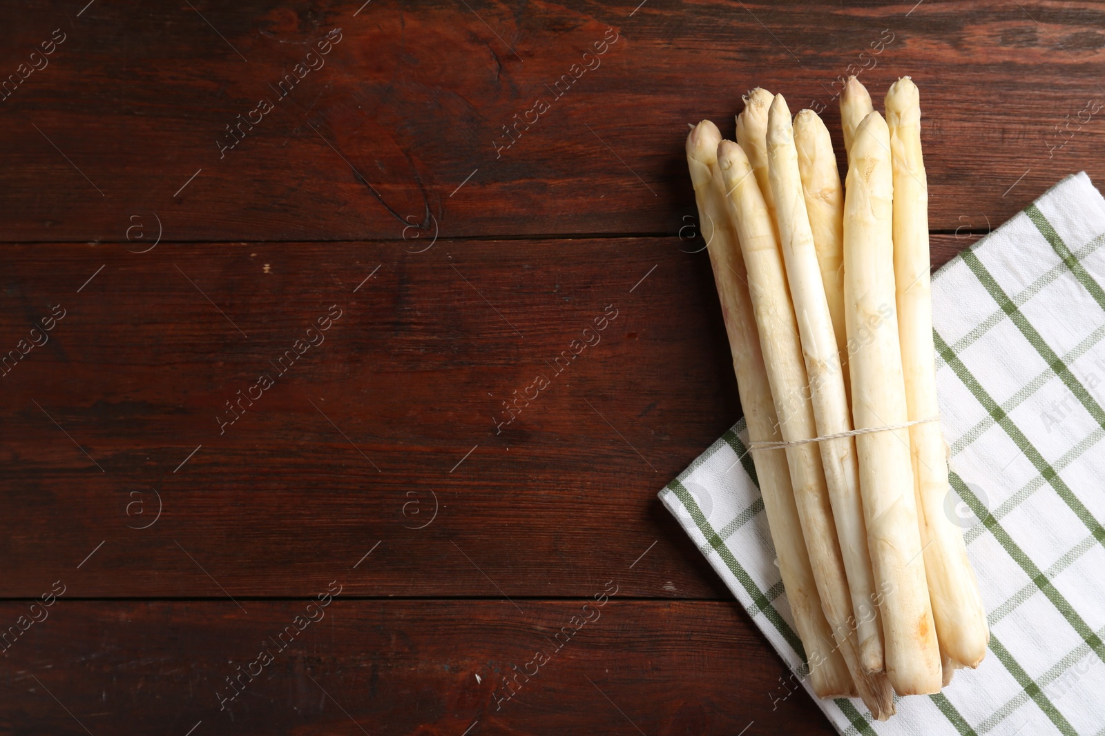 Raw asparagus spears on wooden table, top view. Space for text Photo of Raw asparagus spears on wooden table, top view. Space for text