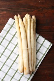 Photo of Raw asparagus spears on wooden table, top view
