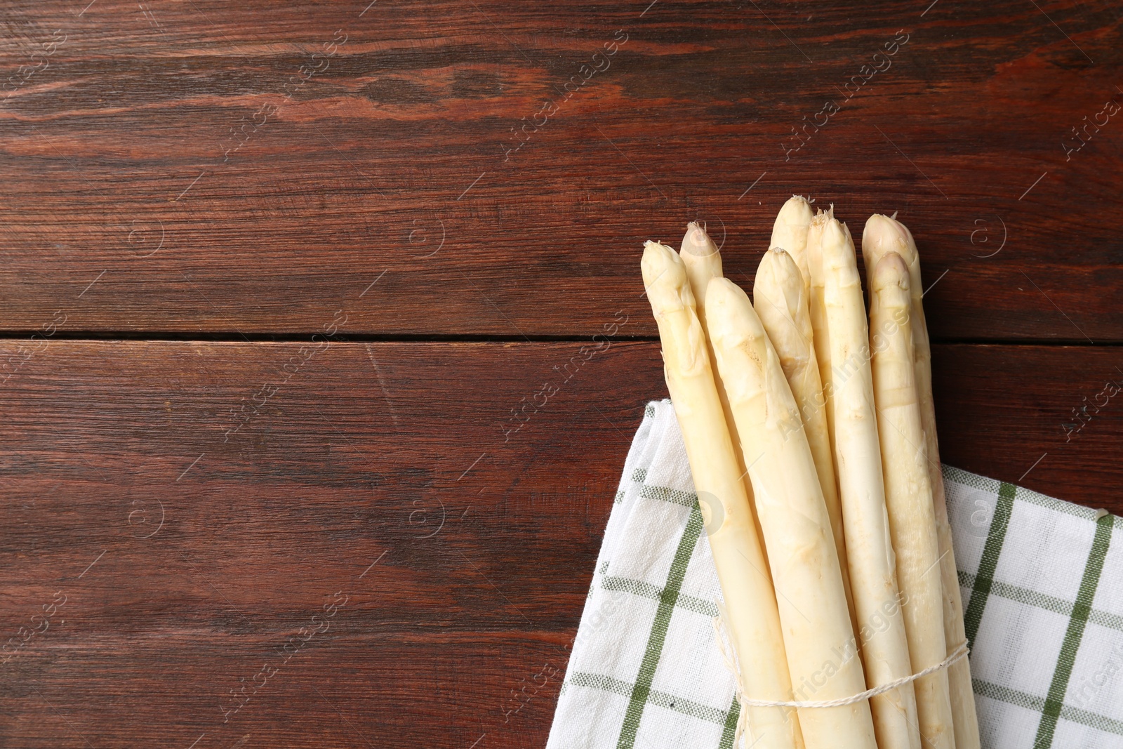 Raw asparagus spears on wooden table, top view. Space for text Photo of Raw asparagus spears on wooden table, top view. Space for text