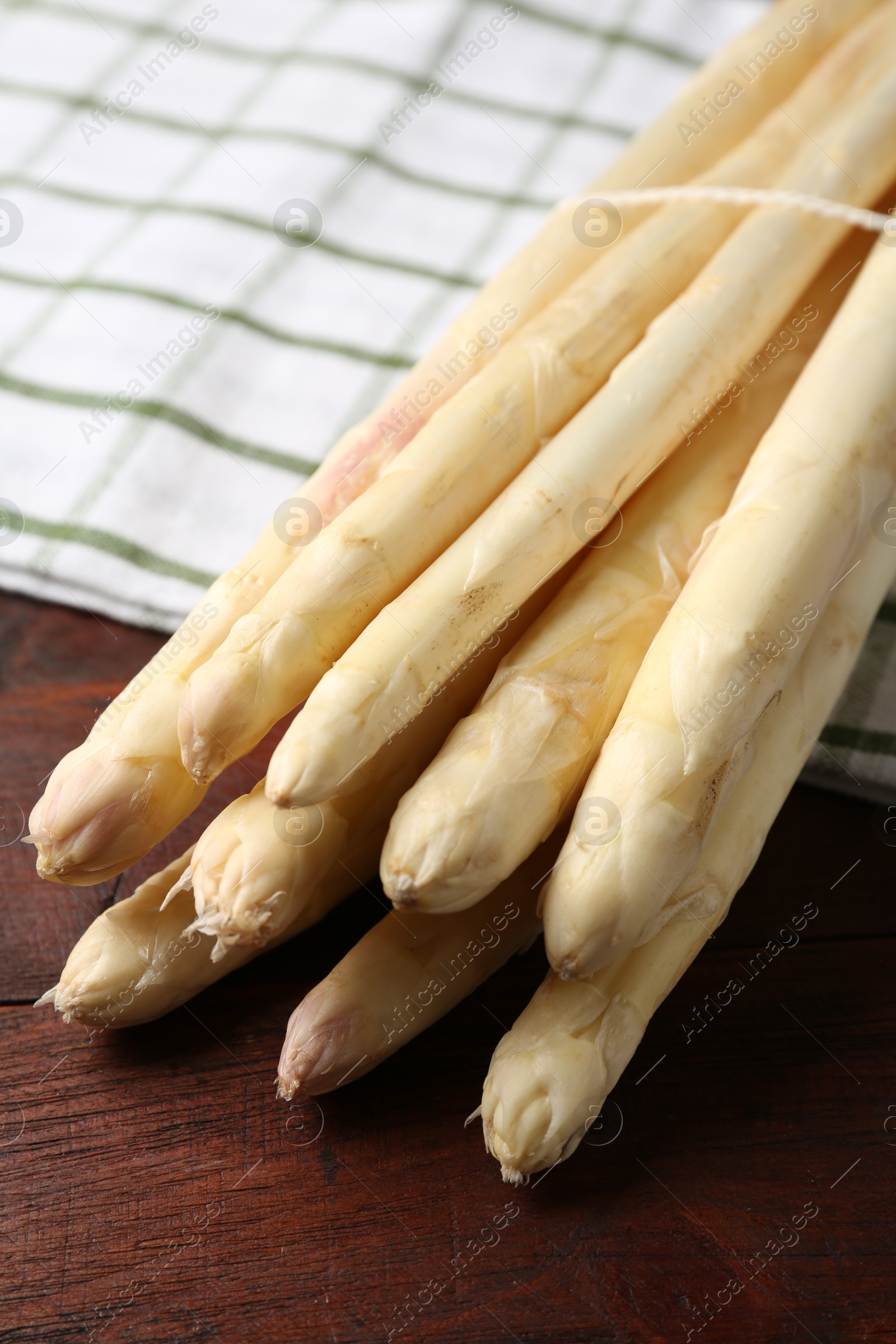 Raw asparagus spears on wooden table, closeup Photo of Raw asparagus spears on wooden table, closeup