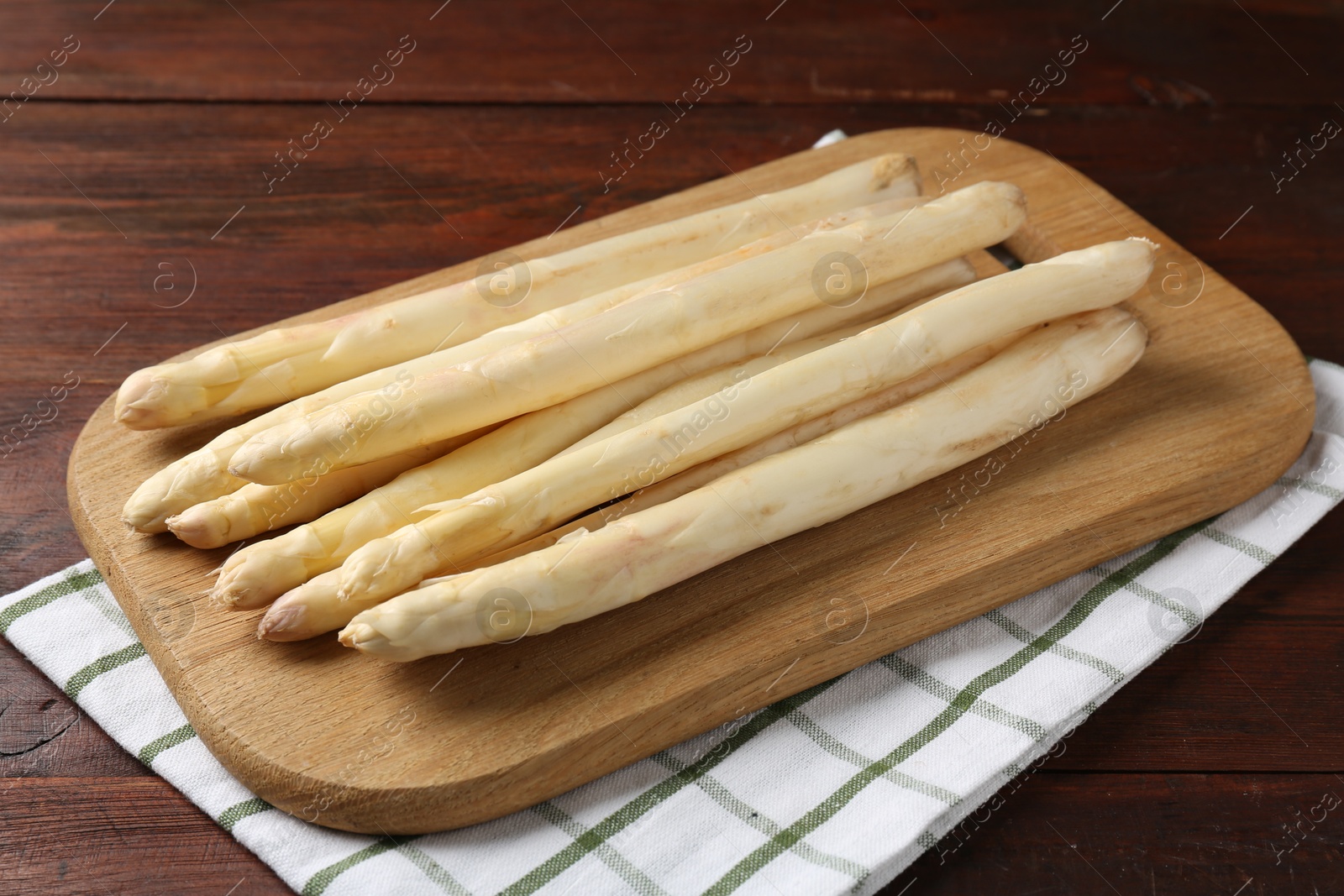 Raw asparagus spears on wooden table, closeup Photo of Raw asparagus spears on wooden table, closeup