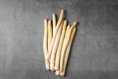 Photo of Many raw asparagus spears on grey table, flat lay