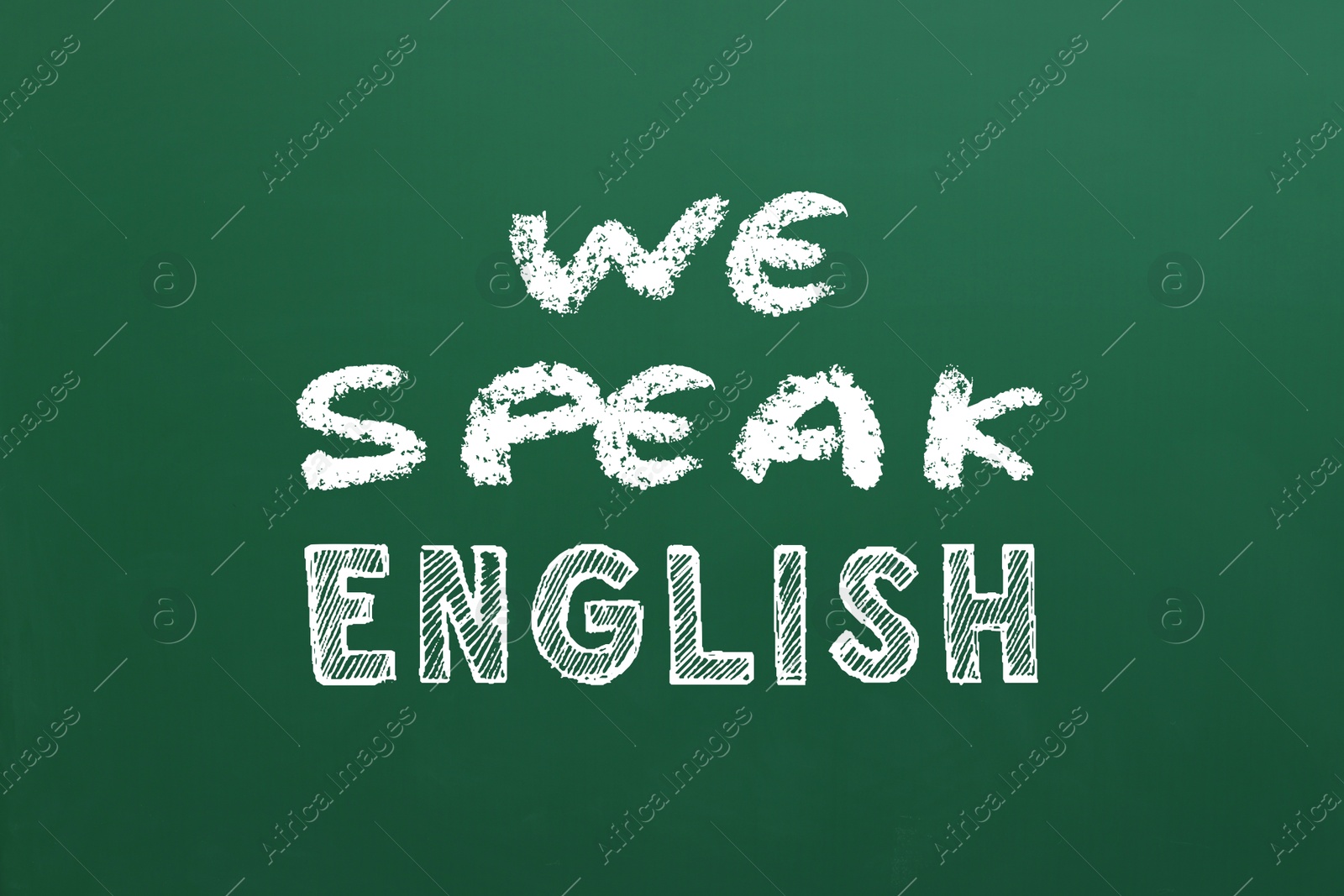 We Speak English inscription on green chalkboard. Language course Image of We Speak English inscription on green chalkboard. Language course