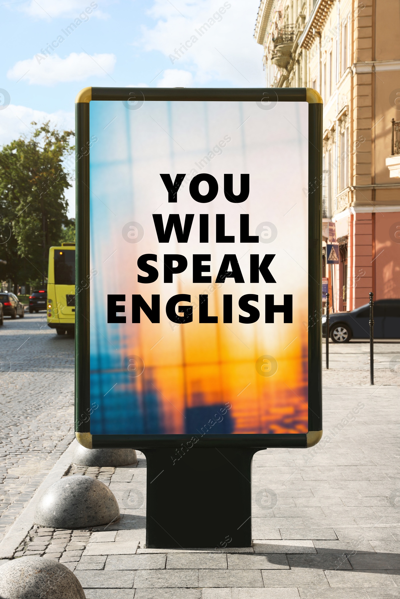 Image of You Will Speak English text on advertising board in city. Language course