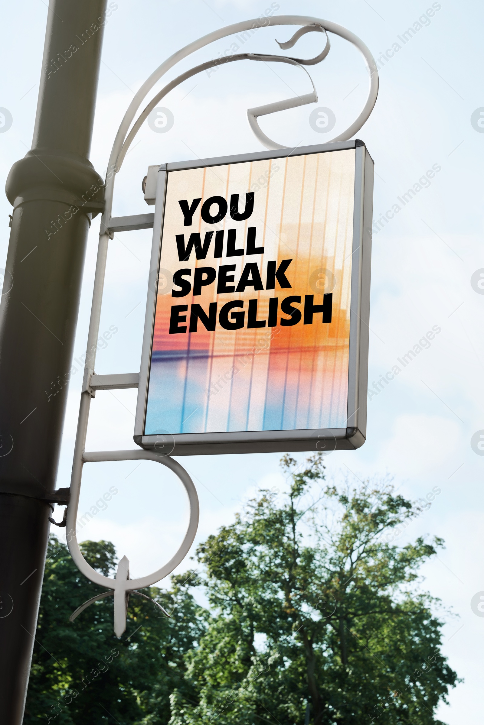 You Will Speak English text on advertising board in city. Language course Image of You Will Speak English text on advertising board in city. Language course