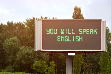 Image of You Will Speak English text on digital billboard outdoors. Language course