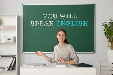 Image of Teacher near green chalkboard with text You Will Speak English in classroom. Language course