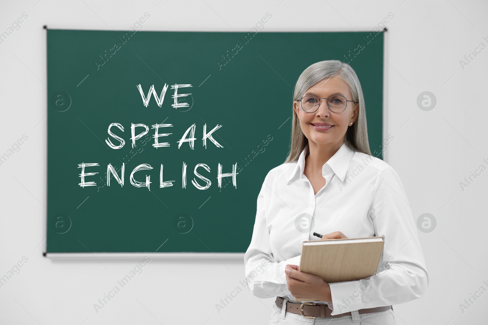 Image of Teacher near green chalkboard with text We Speak English. Language course