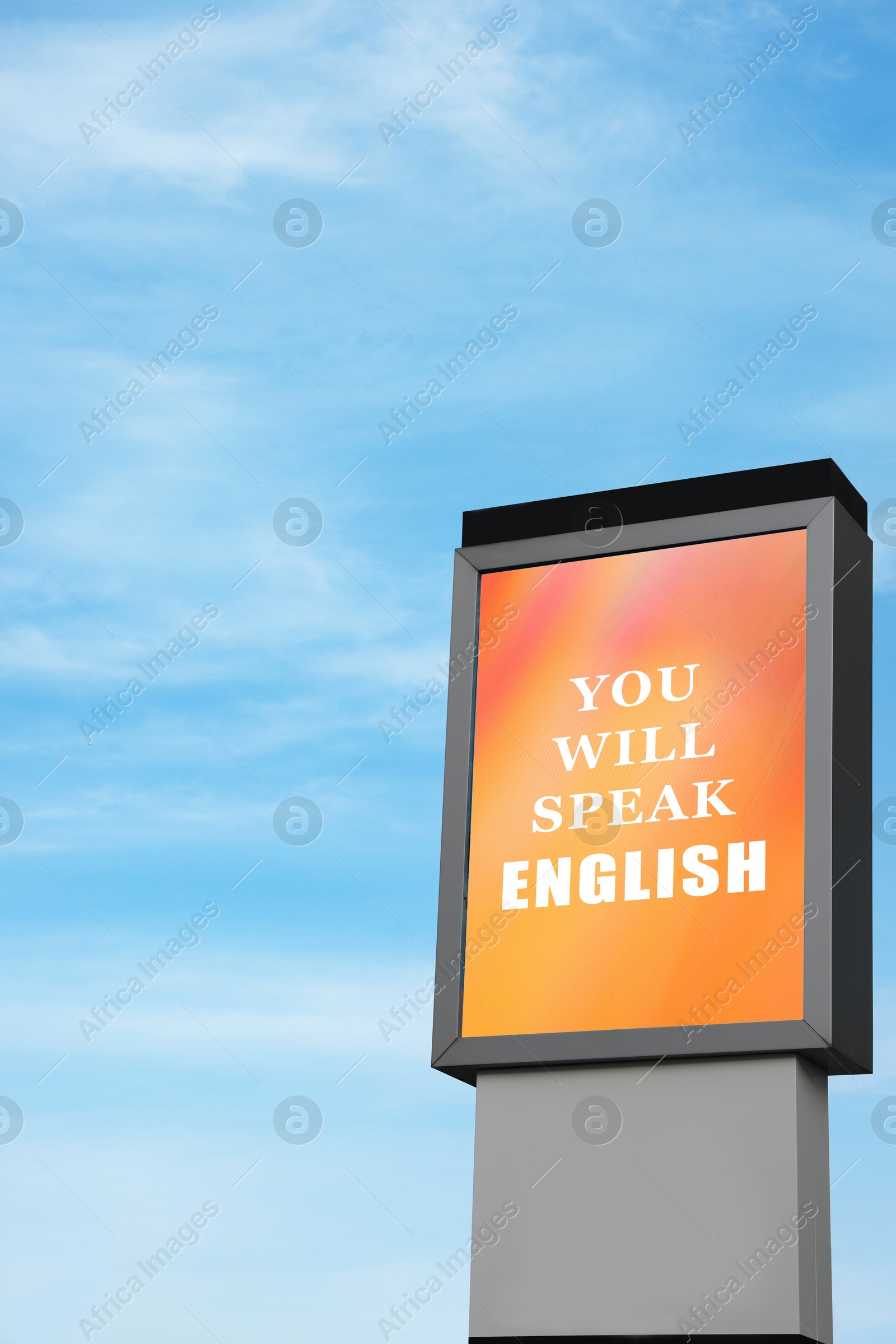 Image of You Will Speak English text on advertising board against blue sky. Language course