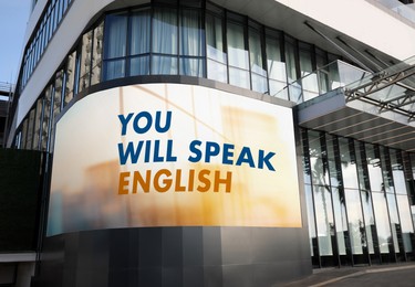 Image of You Will Speak English text on digital billboard in city. Language course