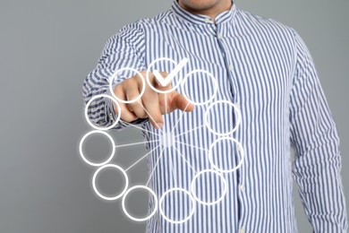 Image of Man putting check mark on virtual screen against grey background, closeup