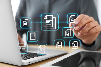 Image of Woman working on laptop at table, closeup, Different document icons on virtual screen