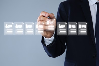 Image of Human resources manager checking candidate's resume on virtual screen against grey background, closeup