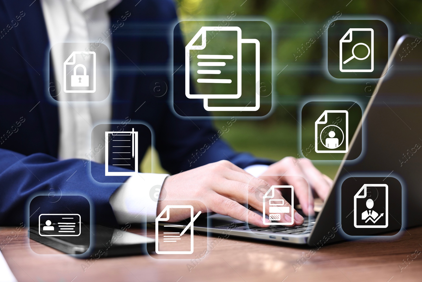 Businessman working on laptop at table, closeup, Different document icons on virtual screen Image of Businessman working on laptop at table, closeup, Different document icons on virtual screen