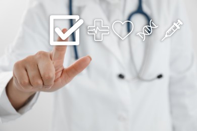 Image of Doctor putting tick into checkbox on virtual screen with healthcare icons, closeup
