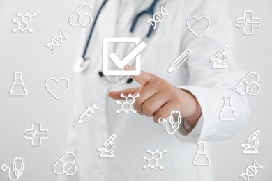 Image of Doctor putting tick into checkbox on virtual screen with healthcare icons, closeup