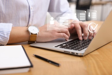 Image of Human resources manager working on laptop at table, closeup. Virtual check mark and resumes over computer