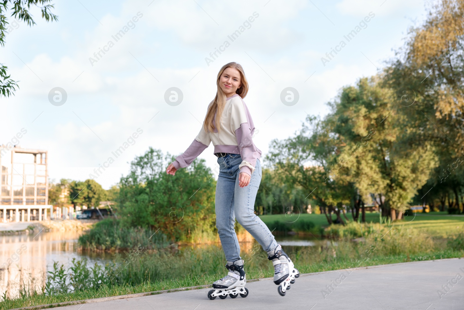 Beautiful young woman roller skating in park Photo of Beautiful young woman roller skating in park