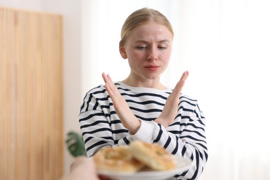 Photo of Gluten free diet. Woman refusing from pretzels indoors
