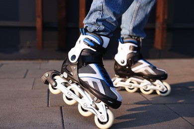 Photo of Man roller skating on city street, closeup